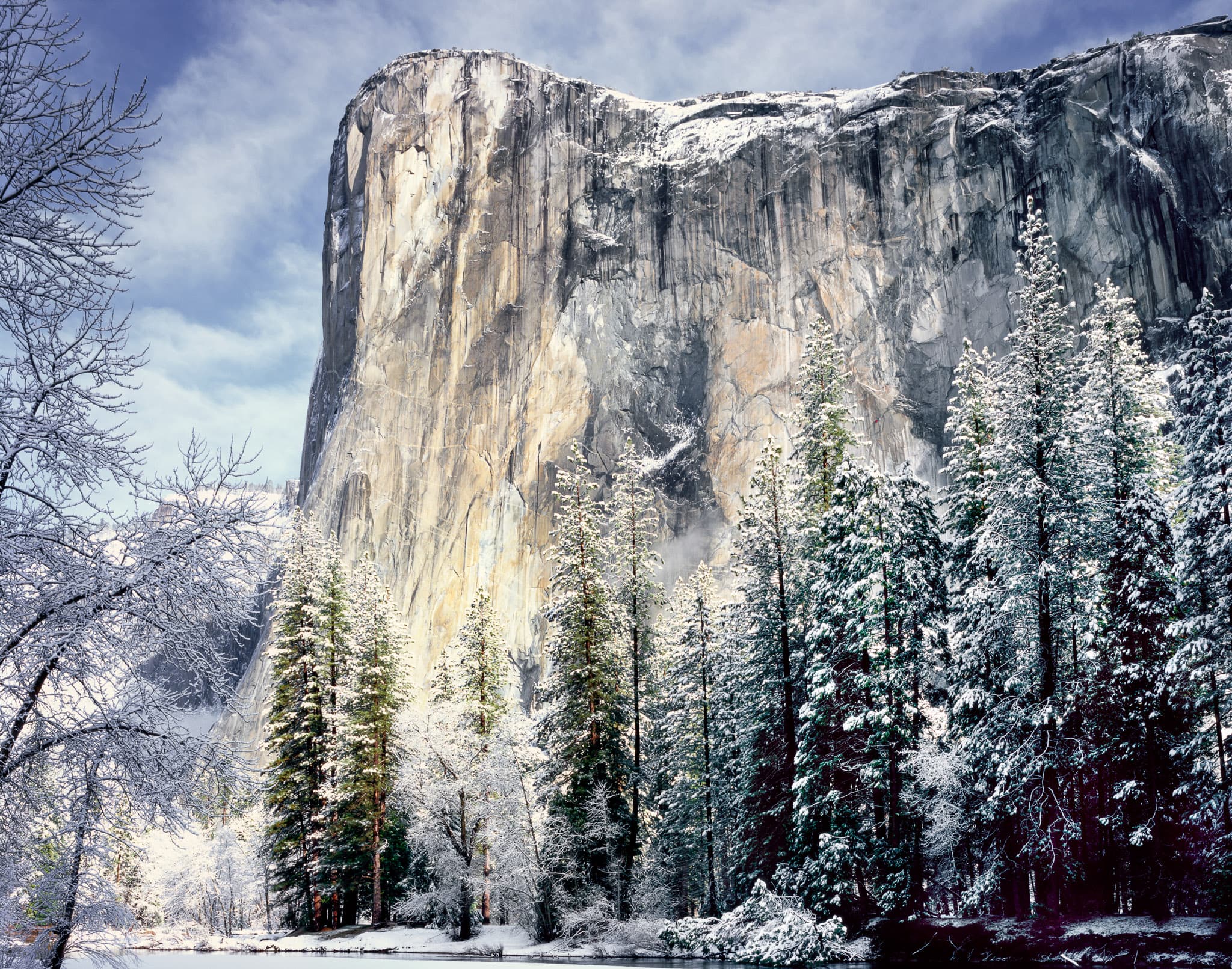 Winter sunrise on El Capitan in Yosemite Valley — the southeast face lit before the valley floor, after a snowfall, California. Photograph by Marty Quinn