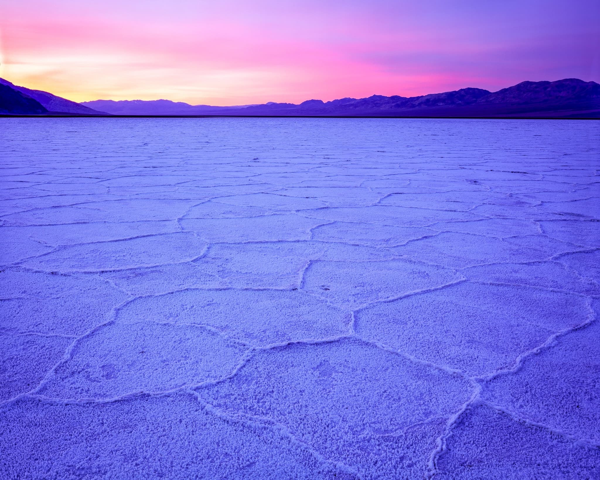 Pink clouds at sunrise over Death Valley's salt flats, shot on Fujichrome Velvia 50 with an Arca-Swiss 4x5 field camera, California. Photograph by Marty Quinn