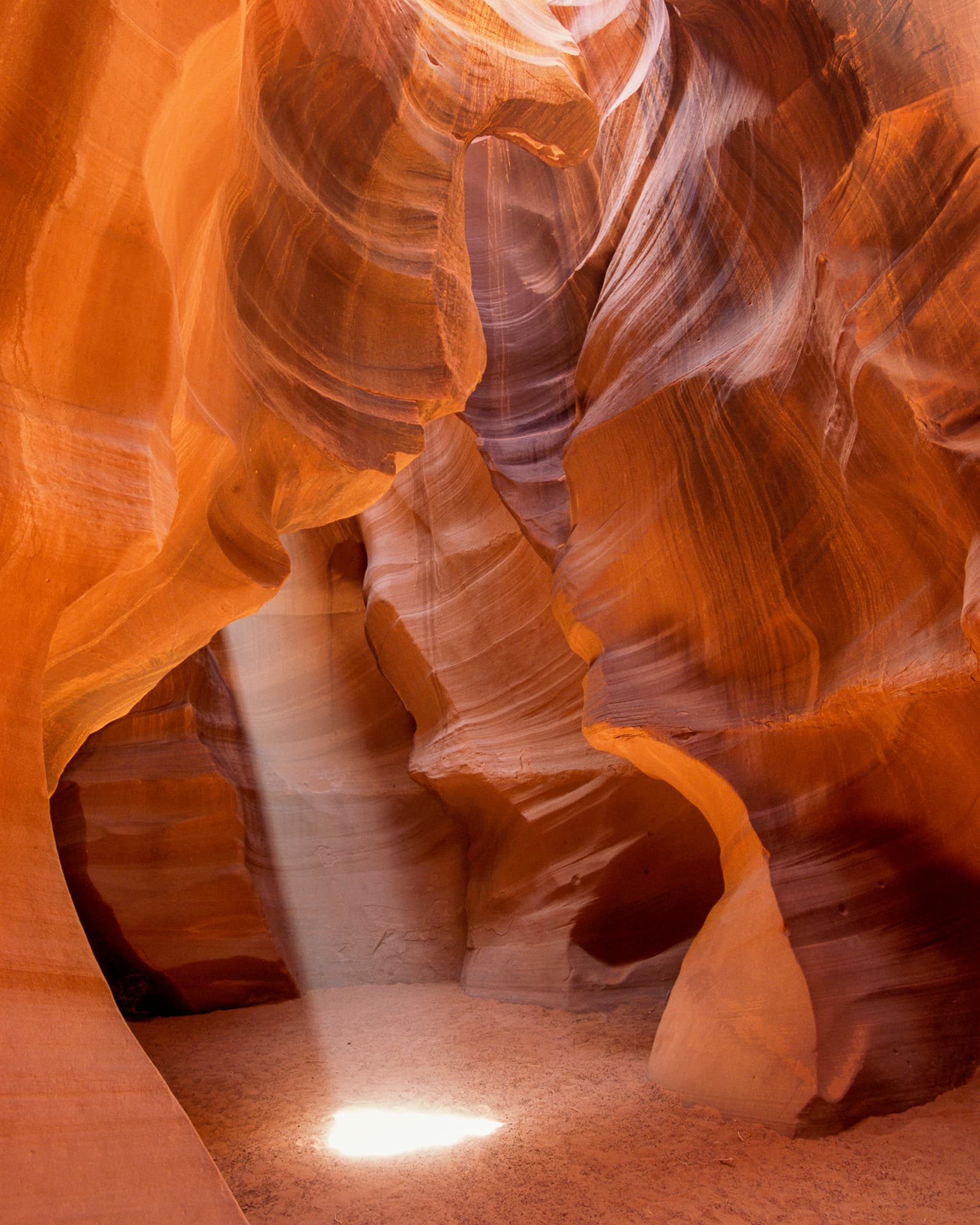 Antelope Canyon near Page, Arizona funnels desert light through narrow slots of sandstone into something that doesn't look real. Photograph by Marty Quinn