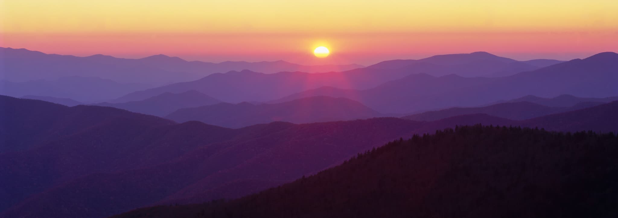 Looking west from Clingmans Dome in Great Smoky Mountains National Park at sunset — the layers of atmospheric haze over the ridgelines rendered in Fujichrome Velvia 50, Tennessee. Photograph by Marty Quinn
